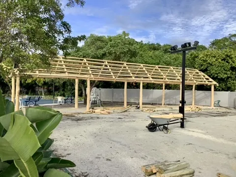 Large timber roof frame under construction in an outdoor space